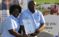 Wilma Chakanetsa (FBC Bank Chinhoyi Branch Manager-left) and Edmore Gandidzanwa(Operations Manager) poses with the Mash West Agricultural Show Exhibition Award